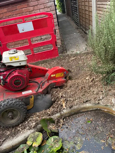 Compact grinder working beside a garden pond